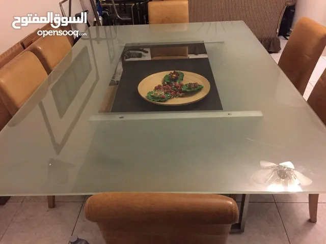Huge beautiful glass top dining table with 6 authentic leather chairs from “The One”