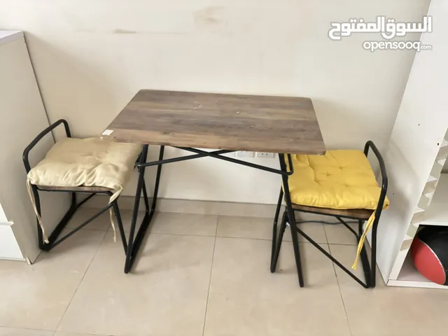 Stylish Folding Table with Yellow Chairs - Perfect for Small Spaces!