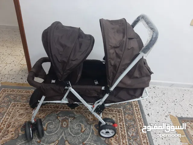 عربه اطفال توأم شبه جديد