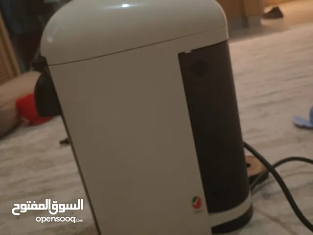 The Nespresso machine is white, about the size and length of a PlayStation, and easy to use