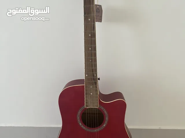 Red guitar, still with tag. Includes guitar bag