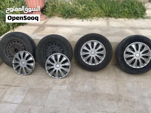 جنط 14 حديد 4 براغي قريب مع طاسات جداد كاوشوك 2 جديد 2 بحالة جيدة