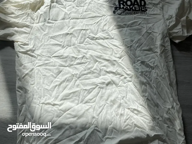 L white and black T shirt , used once but in storage for a pong time .