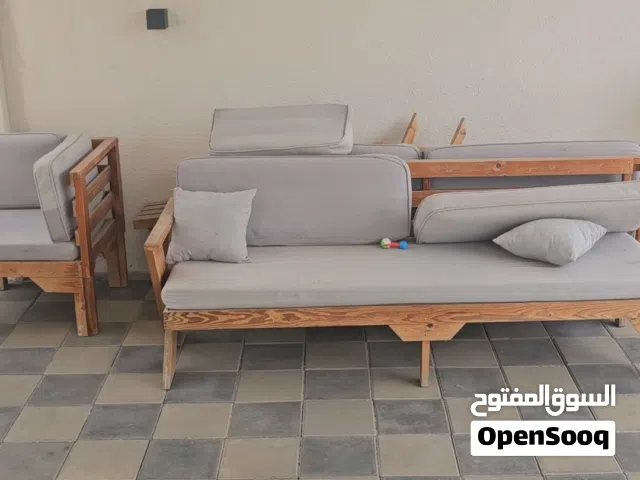 كراسي خارجية مع طاولة كبيرة وطاولتين صغيرة