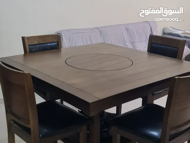wooden dinning table spins in the middle with four chairs