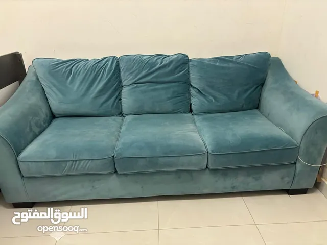 Bed with mattress and sofa with cushions