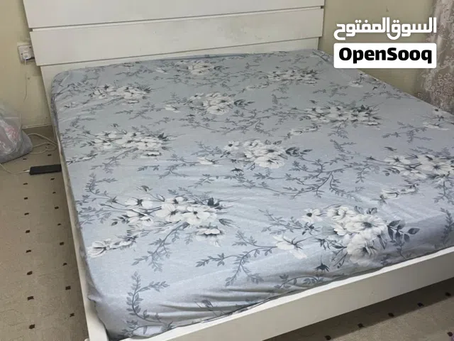 bed, paintings, office desk