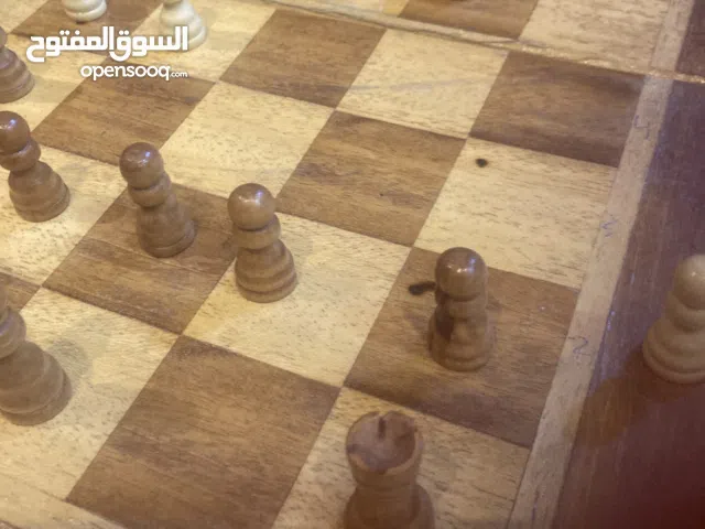 Wooden chess board with wooden pieces.