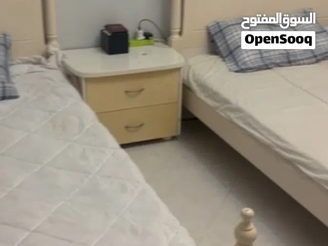 Two single beds with mattresses and bedside table (cream finish)