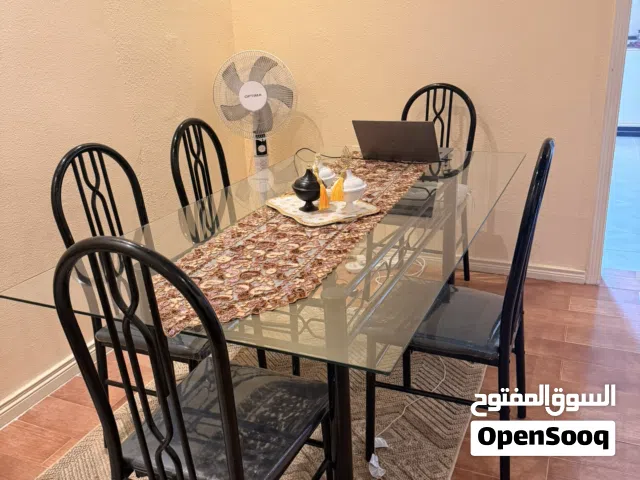 1 Dining table (Glass) + 5 chairs  Black Color & Midnight blue chair seat cushion  USED